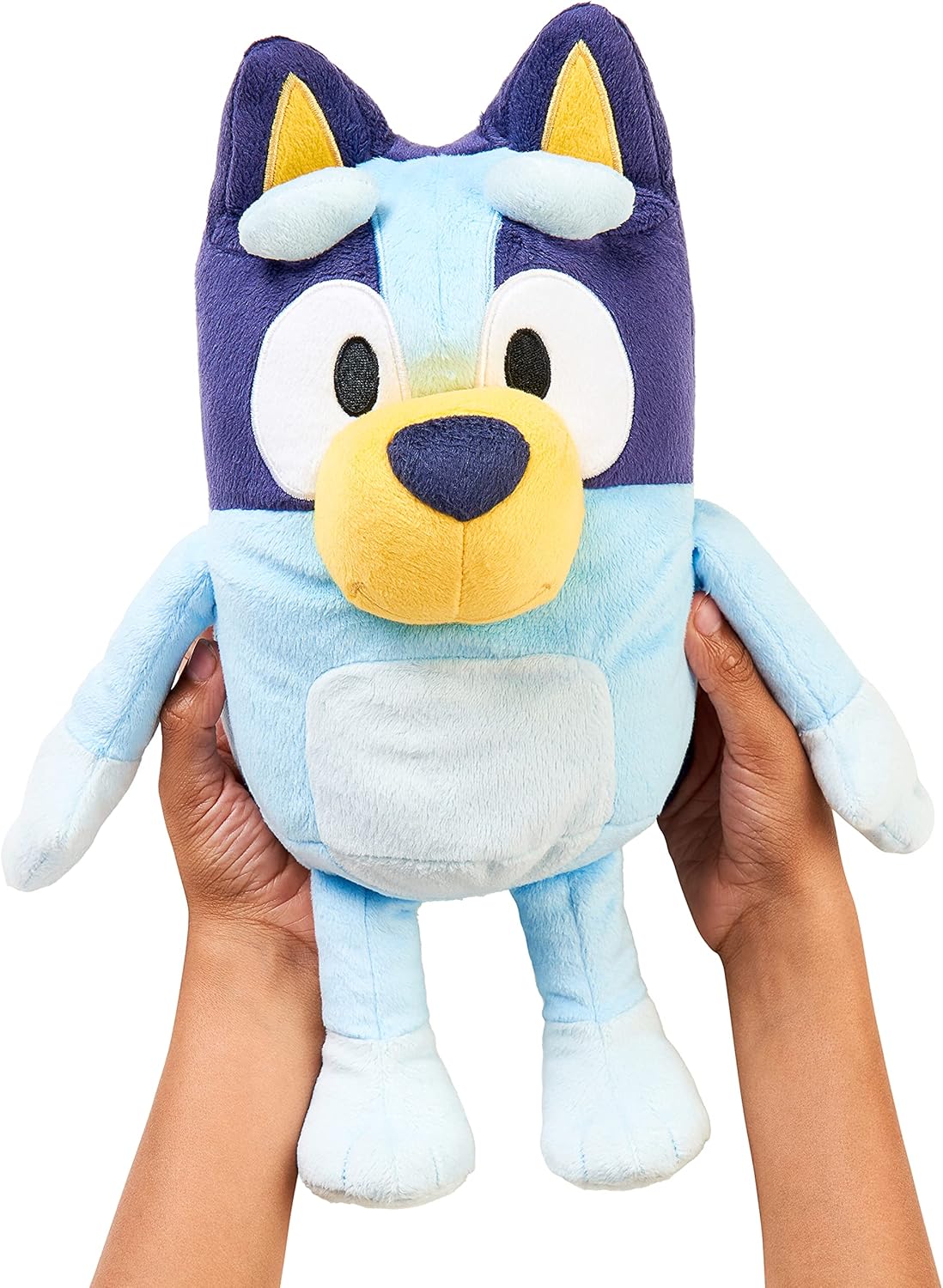 Hands holding Bluey interactive stuffed animal toy closeup